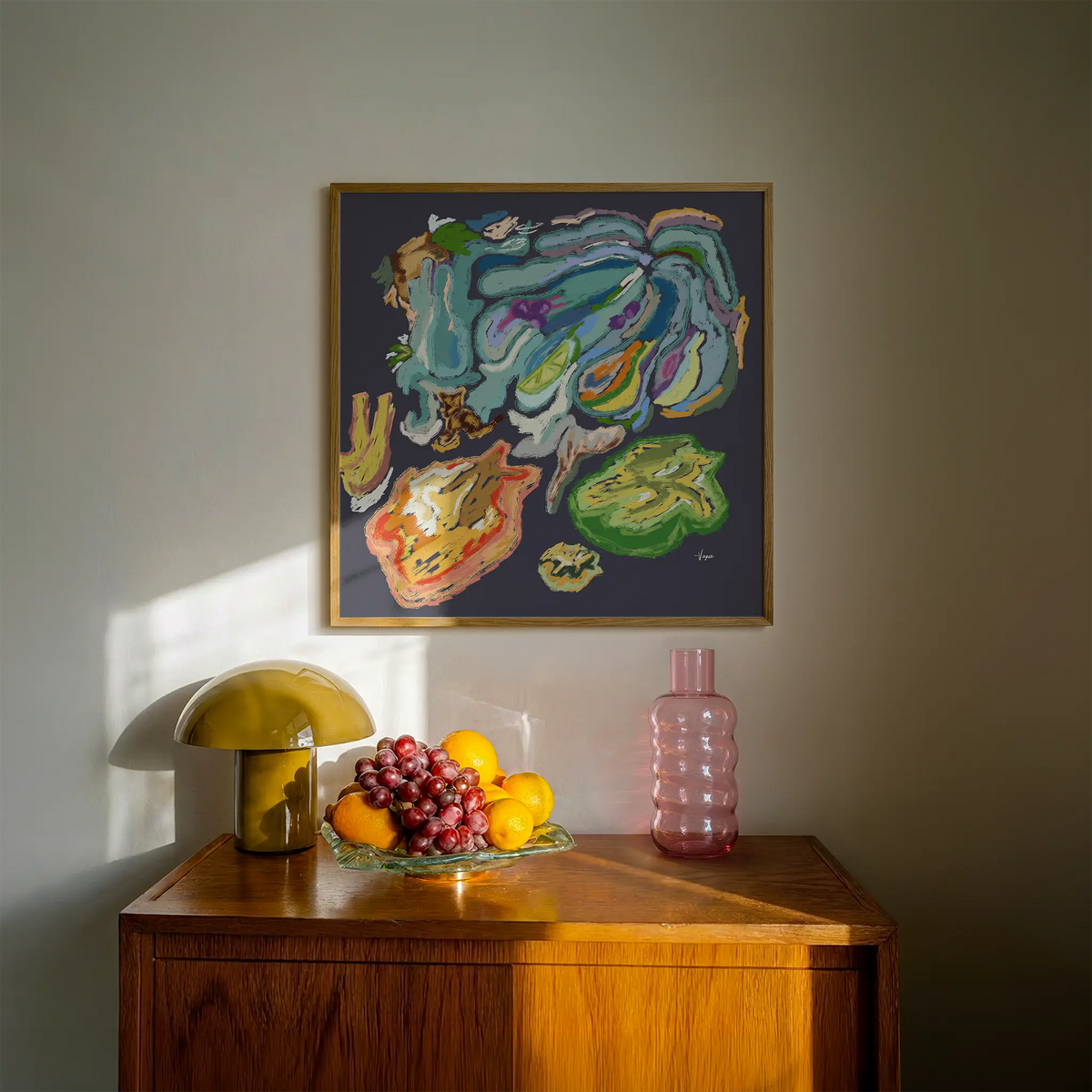 Framed abstract wall art on wall with colorful hand-painted style, medium brown frame