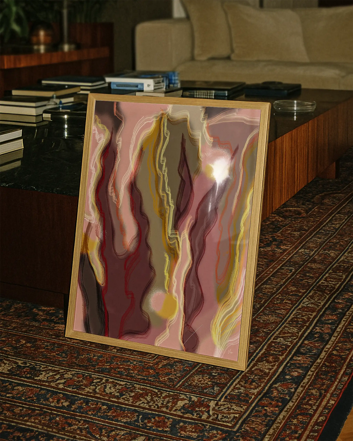 Framed abstract wall art with marbled pink, yellow, and red lines in light wood frame